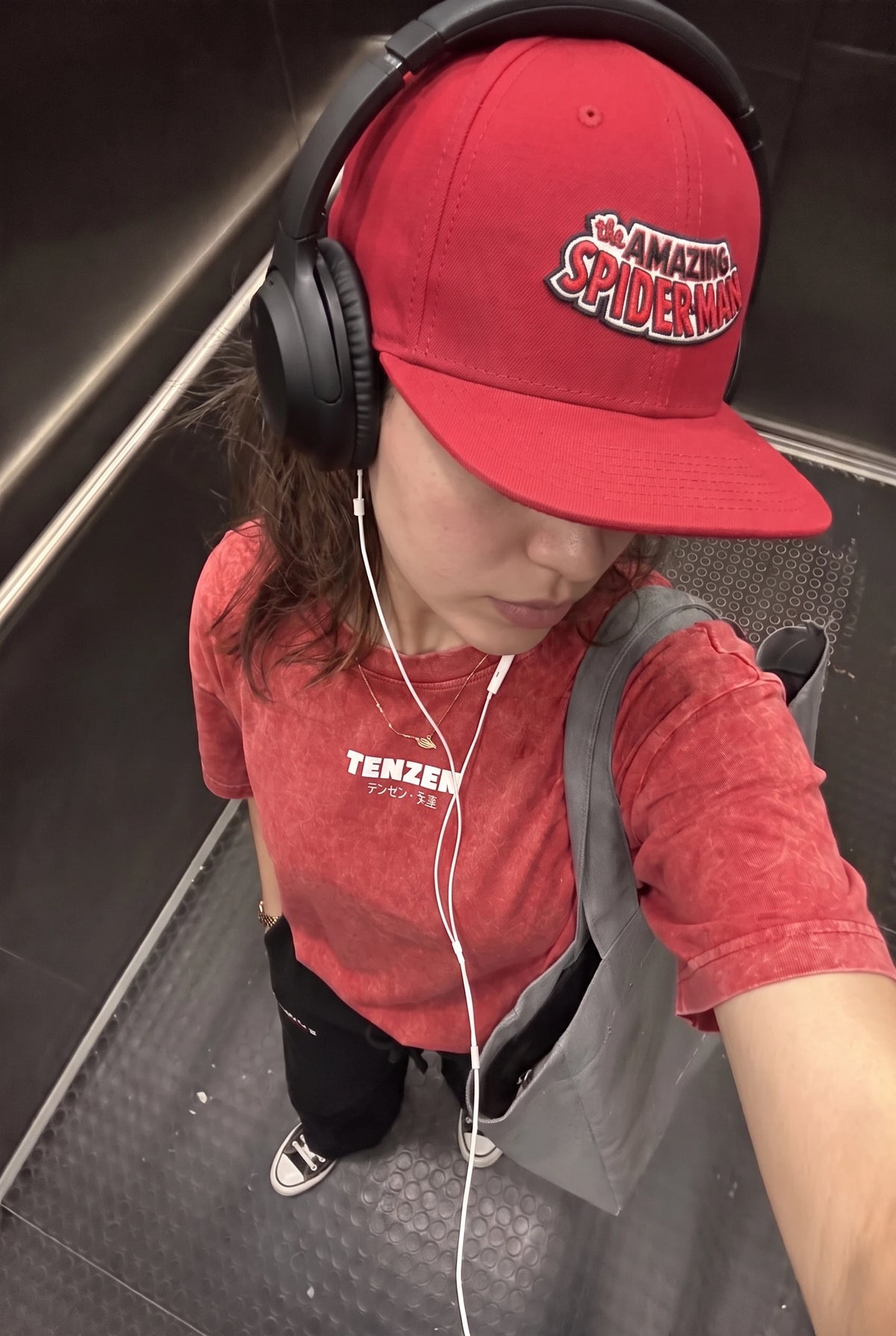 TASM red snapback cap angled view on female model
